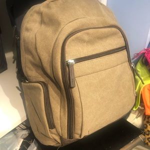 Large canvas back.  Inside pocket is padded. 11” high. 10” wide